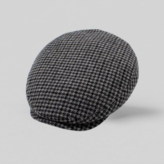 Grå sixpence i uld med houndstooth-mønster, fremstillet i Italien – set fra oven mod grå baggrund