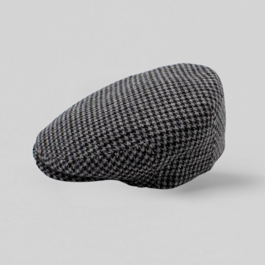 Grå sixpence i uld med houndstooth-mønster, fremstillet i Italien – set fra siden mod grå baggrund