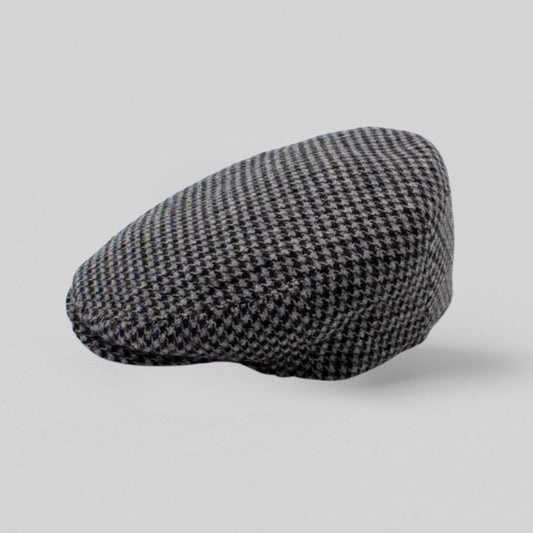 Grå sixpence i uld med houndstooth-mønster, fremstillet i Italien – set fra siden mod grå baggrund