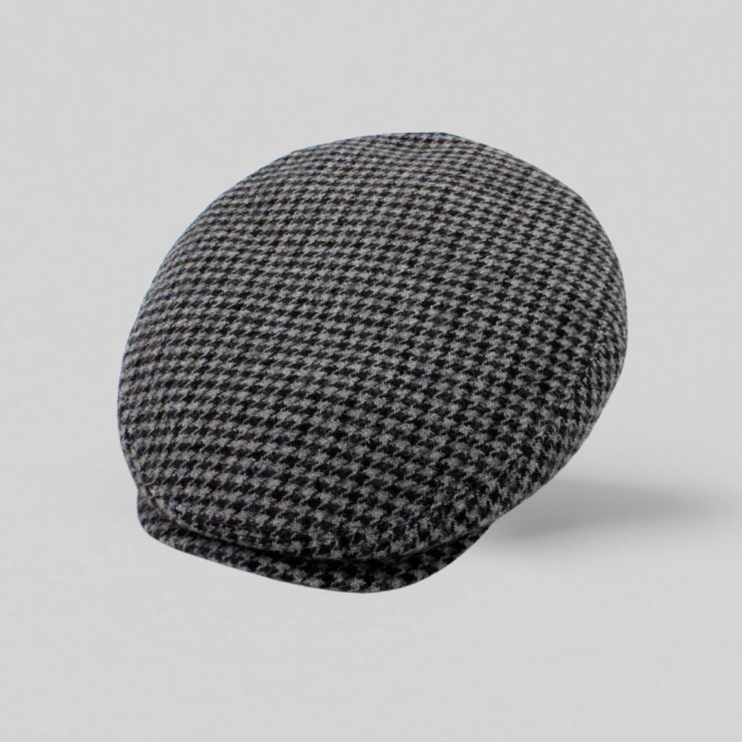 Grå sixpence i uld med houndstooth-mønster, fremstillet i Italien – set fra oven mod grå baggrund